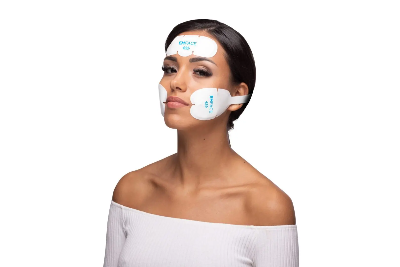 Woman wearing at-home facial toning device pads